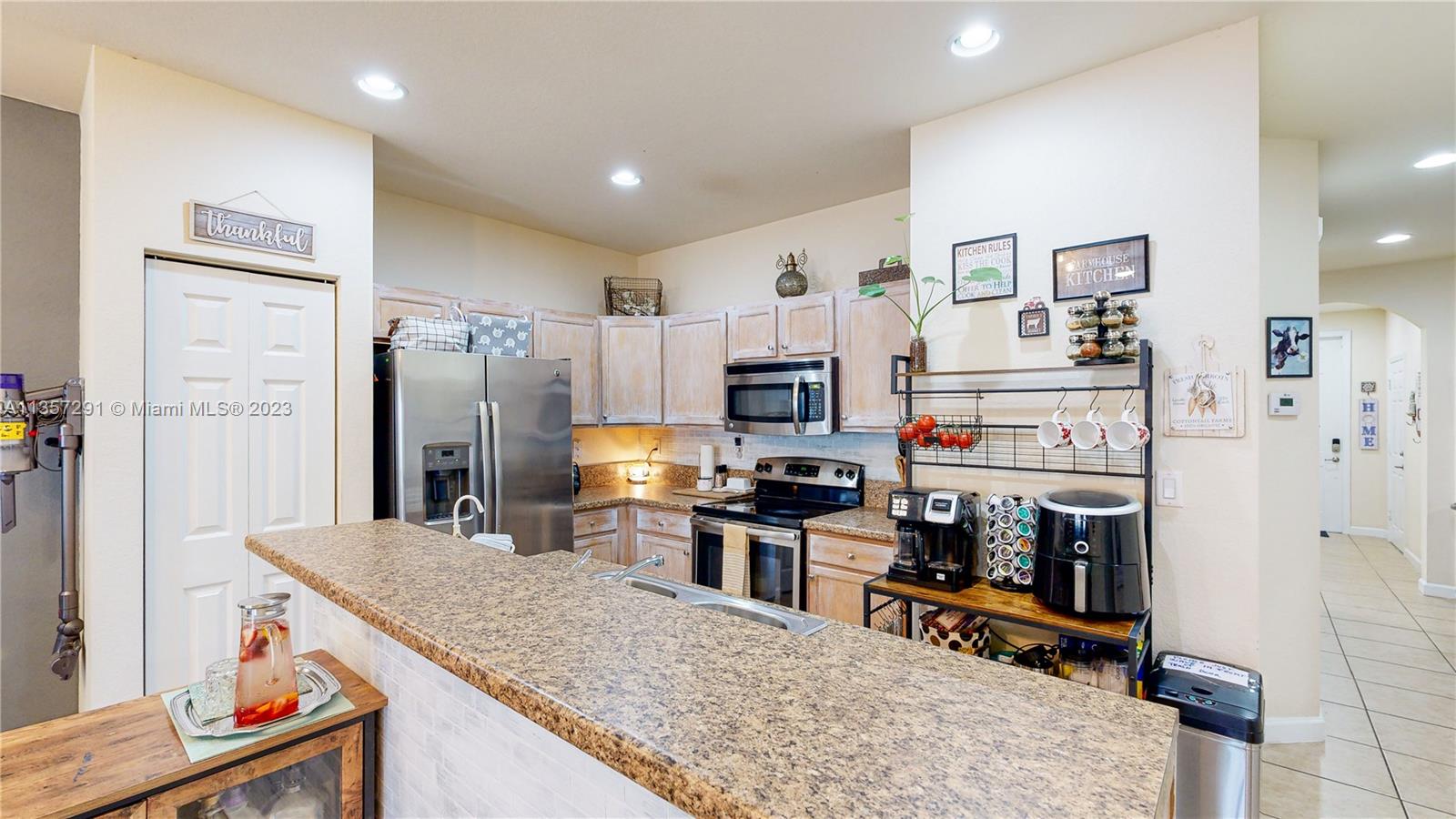 672 Southeast 34th Avenue Homestead, FL 33033 - Photo 15 of 65 a kitchen with stainless steel appliances granite countertop a refrigerator stove microwave and sink