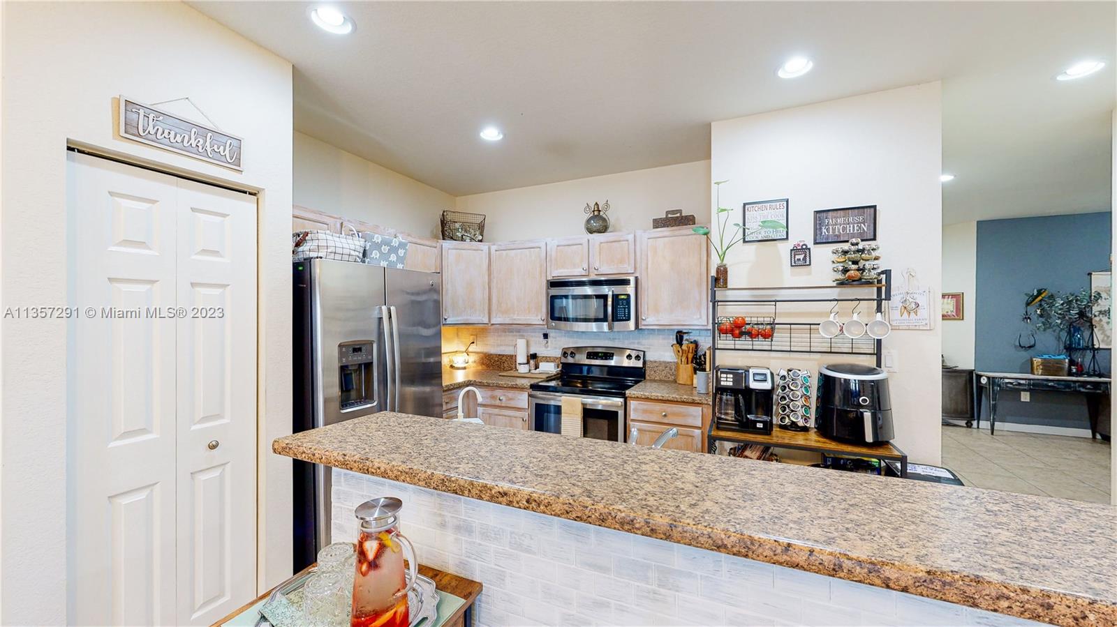 672 Southeast 34th Avenue Homestead, FL 33033 - Photo 16 of 65 a kitchen with stainless steel appliances granite countertop a refrigerator and a stove