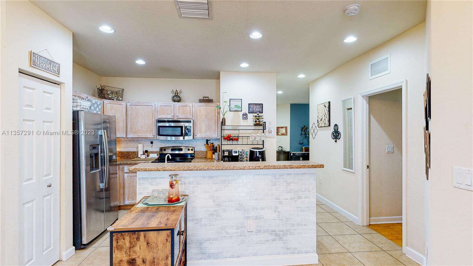 672 Southeast 34th Avenue Homestead, FL 33033 - Photo 18 of 65 a kitchen with stainless steel appliances granite countertop a refrigerator and a stove top oven