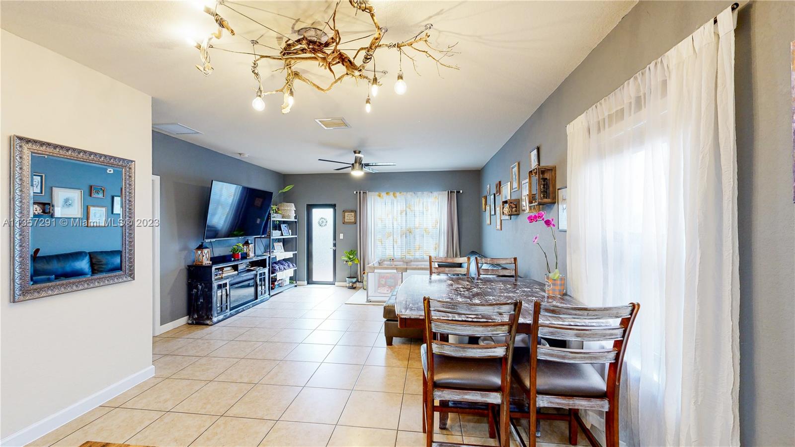 672 Southeast 34th Avenue Homestead, FL 33033 - Photo 19 of 65 a view of a dining room with furniture and a chandelier