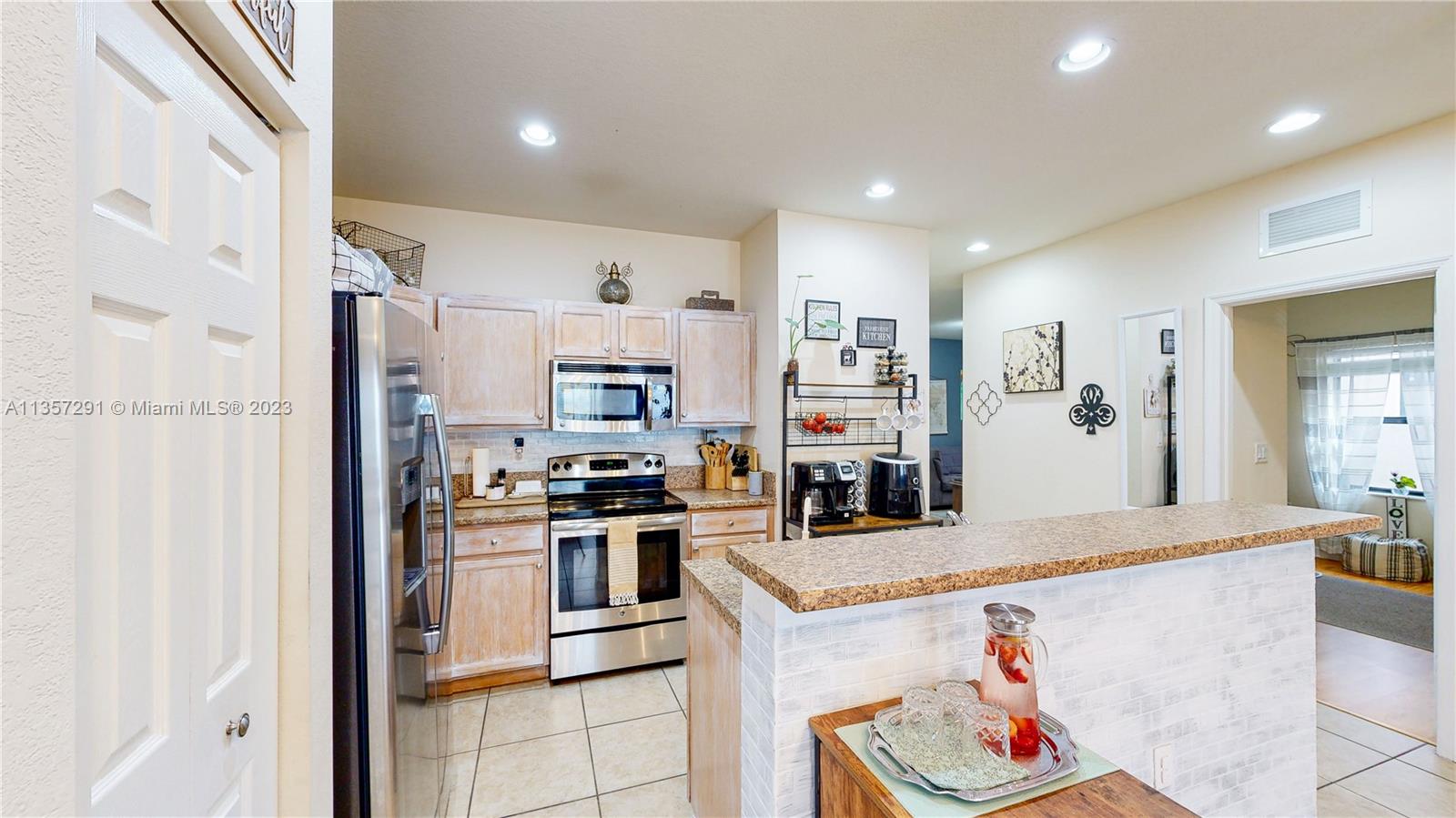 672 Southeast 34th Avenue Homestead, FL 33033 - Photo 2 of 65 a kitchen with stainless steel appliances granite countertop a refrigerator and a sink