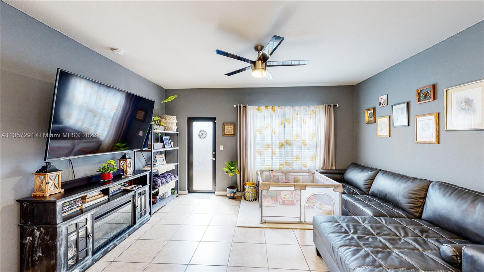672 Southeast 34th Avenue Homestead, FL 33033 - Photo 22 of 65 a living room with furniture and a flat screen tv