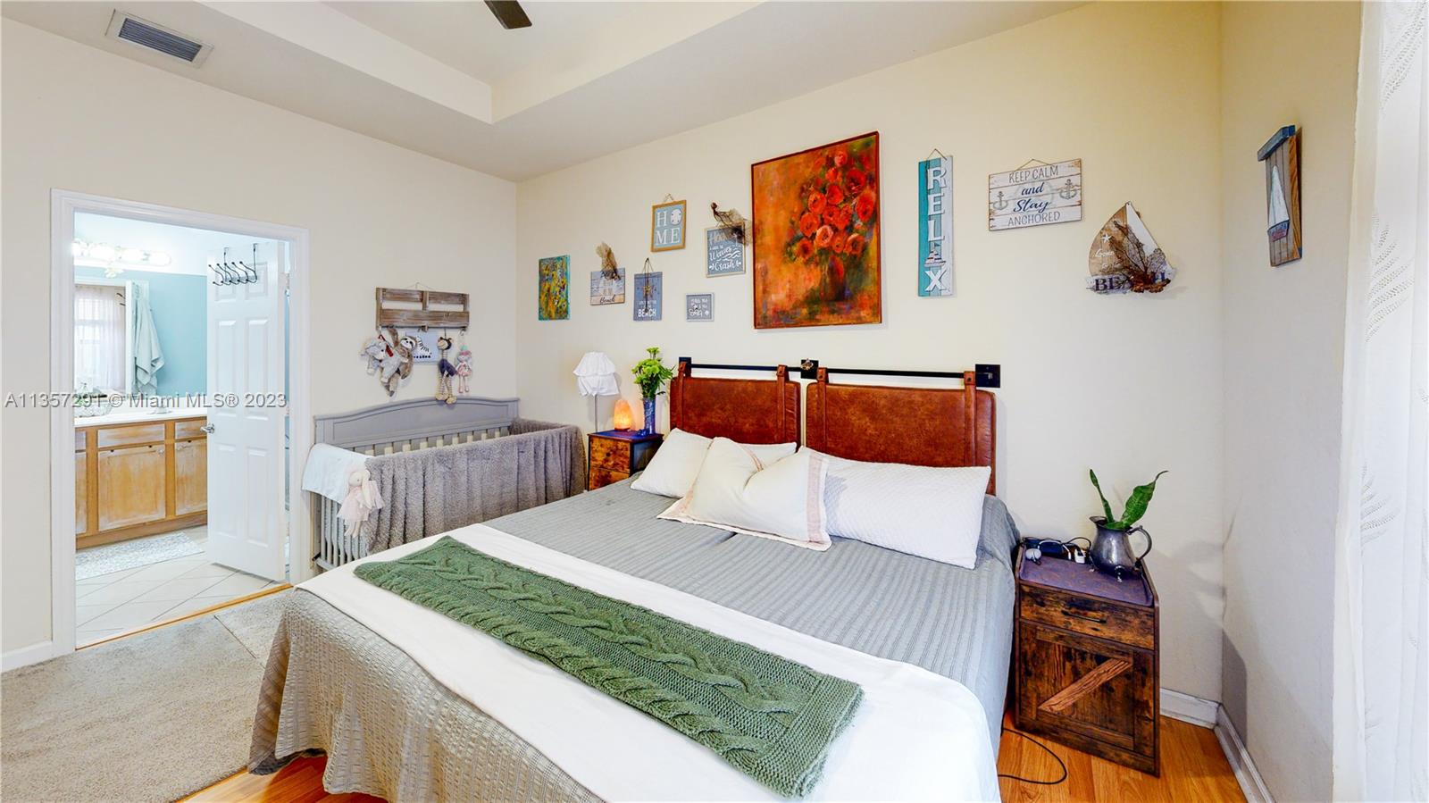 672 Southeast 34th Avenue Homestead, FL 33033 - Photo 26 of 65 a bedroom with a bed and a painting on the wall