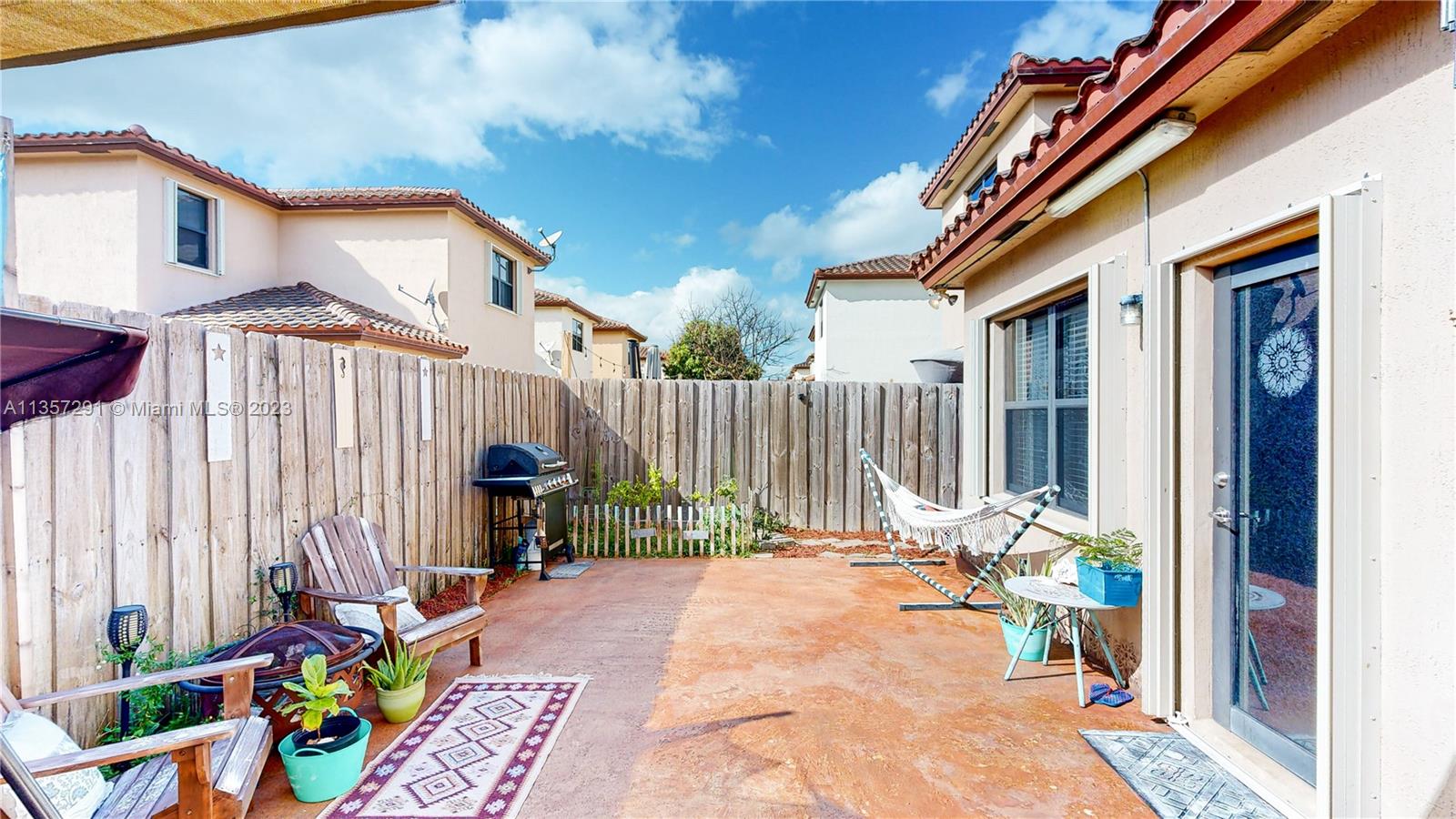 672 Southeast 34th Avenue Homestead, FL 33033 - Photo 37 of 65 a backyard of a house with barbeque oven table and chairs