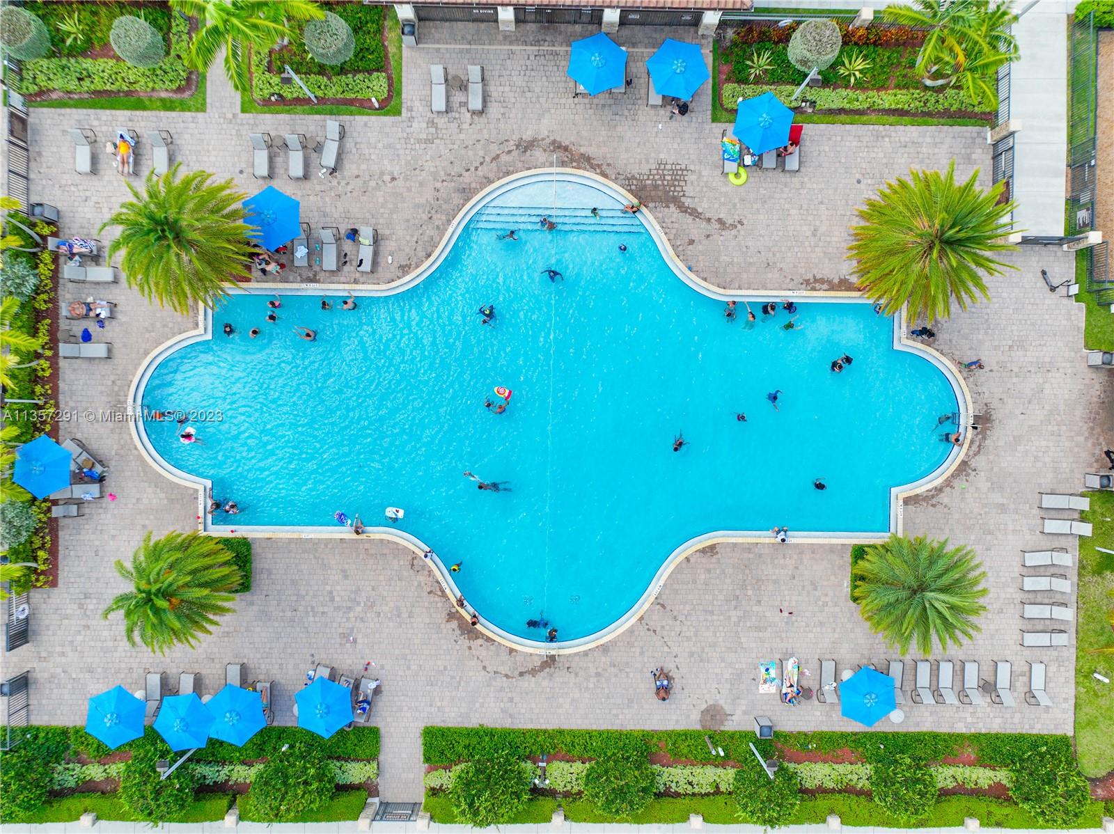672 Southeast 34th Avenue Homestead, FL 33033 - Photo 52 of 65 an aerial view of a swimming pool with outdoor seating and yard