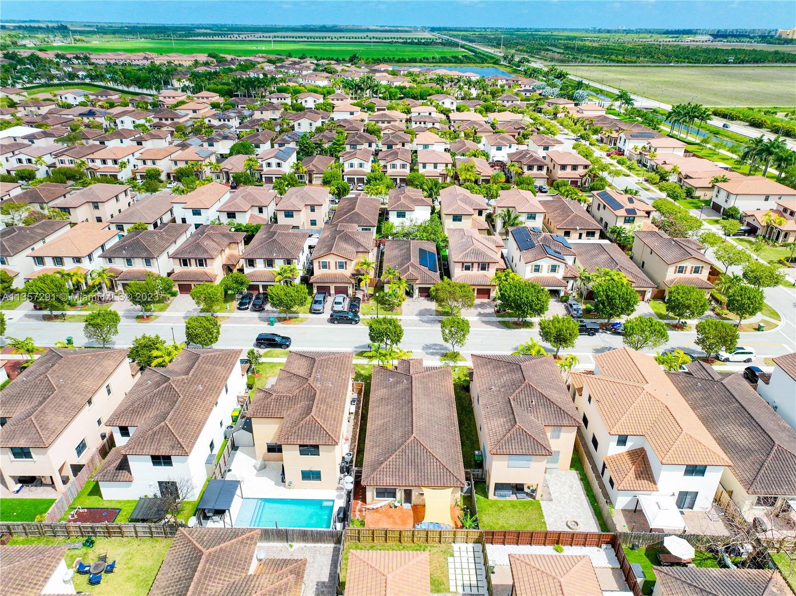 672 Southeast 34th Avenue Homestead, FL 33033 - Photo 57 of 65 an aerial view of residential houses with outdoor space and trees