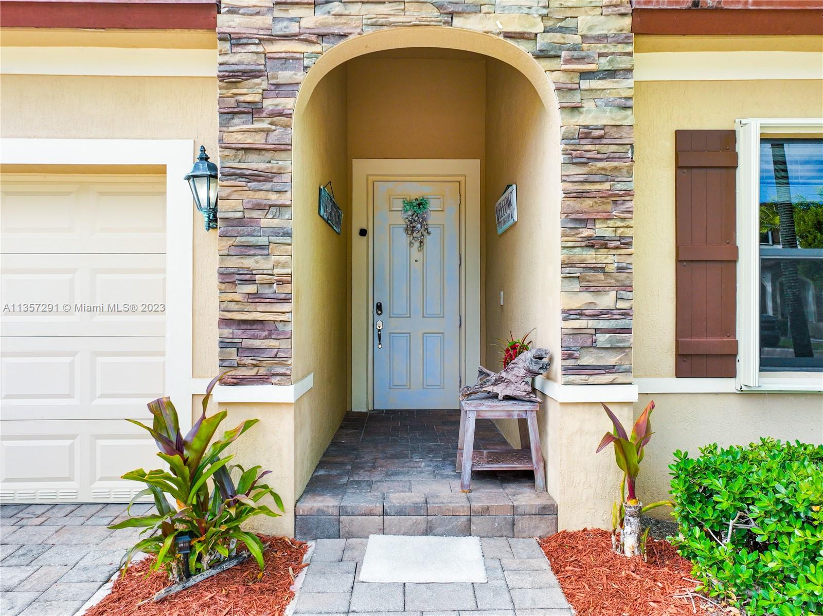 672 Southeast 34th Avenue Homestead, FL 33033 - Photo 6 of 65 a front view of a house with outdoor seating