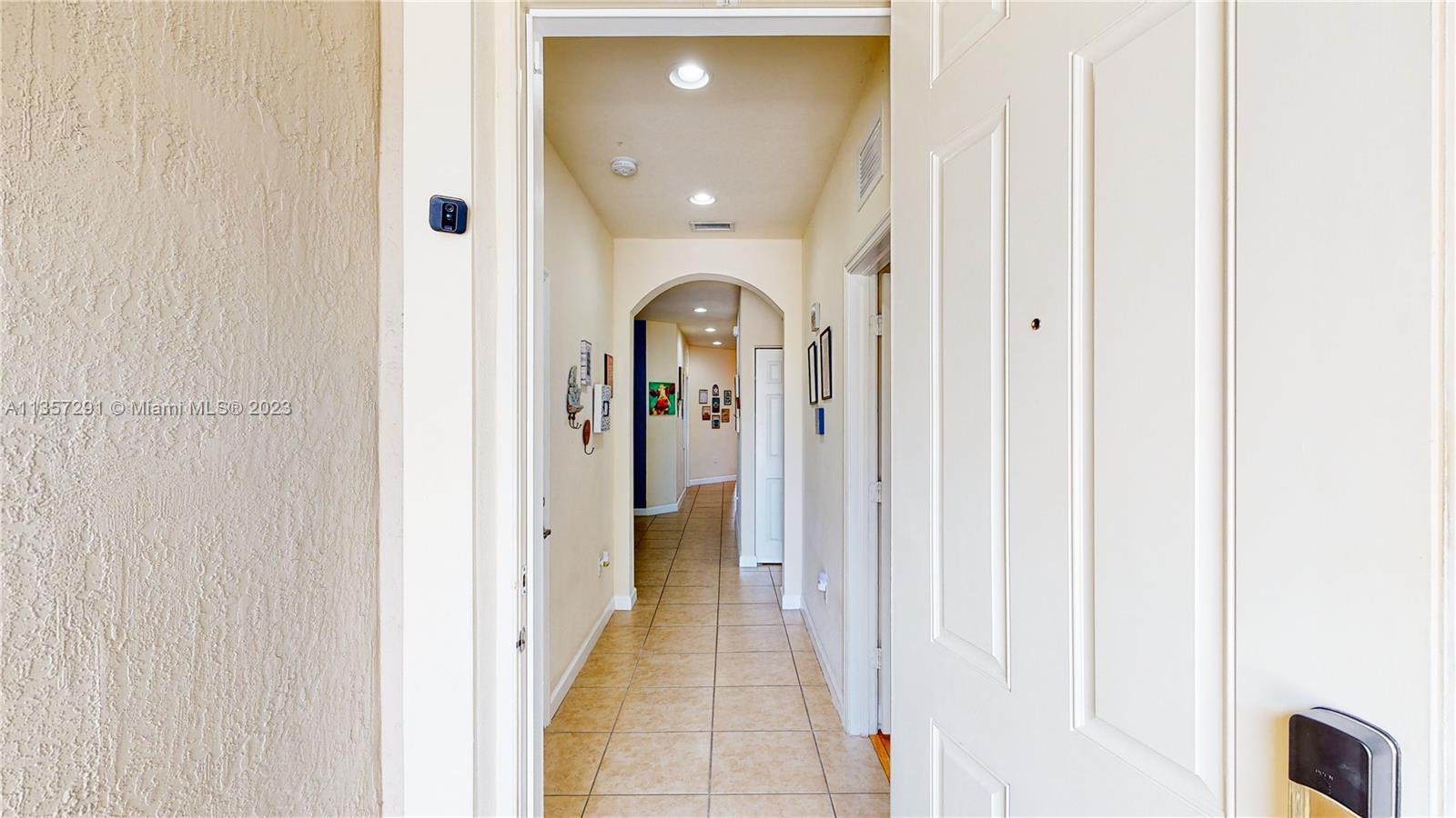 672 Southeast 34th Avenue Homestead, FL 33033 - Photo 7 of 65 a view of a hallway with wooden floor and a bathroom
