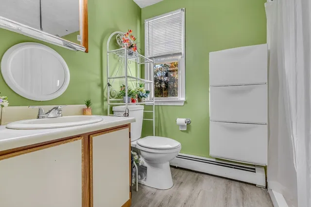 a bathroom with a sink mirror vanity and toilet