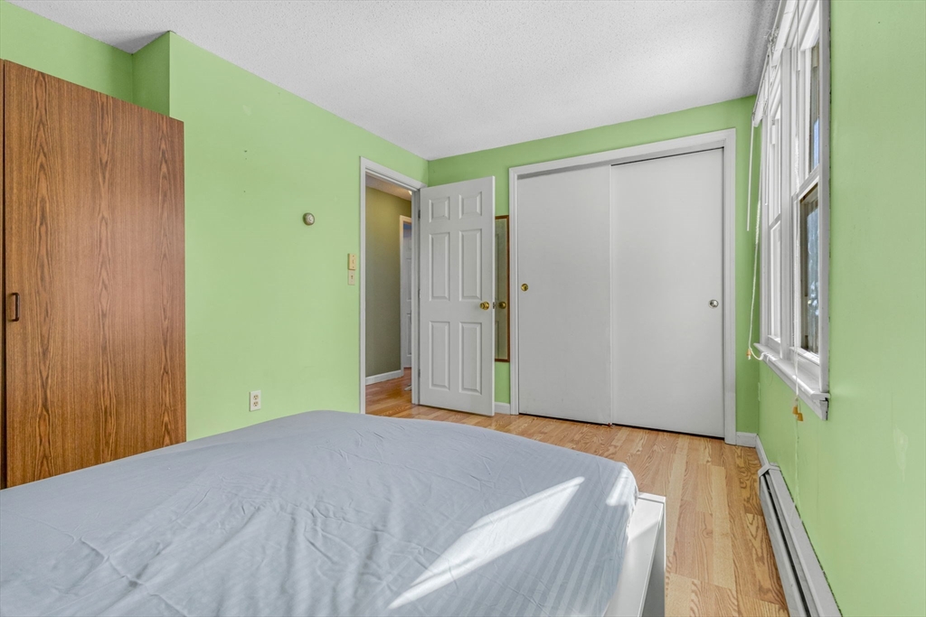 46 Vincent Circle Worcester, MA 01604 - Photo 17 of 27 a bedroom with a bed and wooden floor