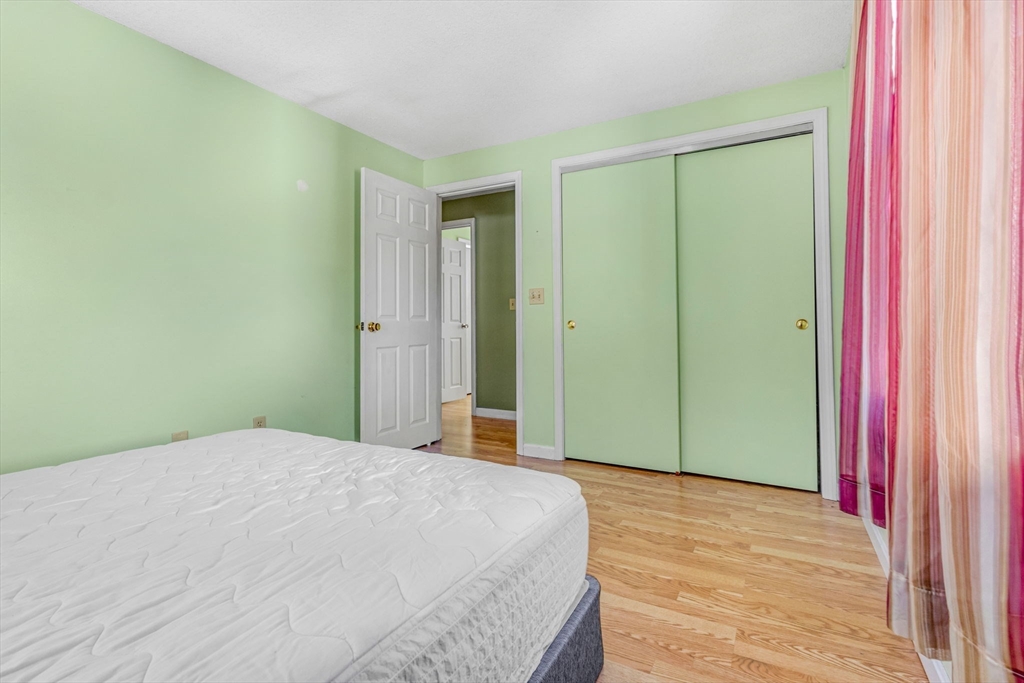 46 Vincent Circle Worcester, MA 01604 - Photo 19 of 27 a bedroom with a bed and a mirror