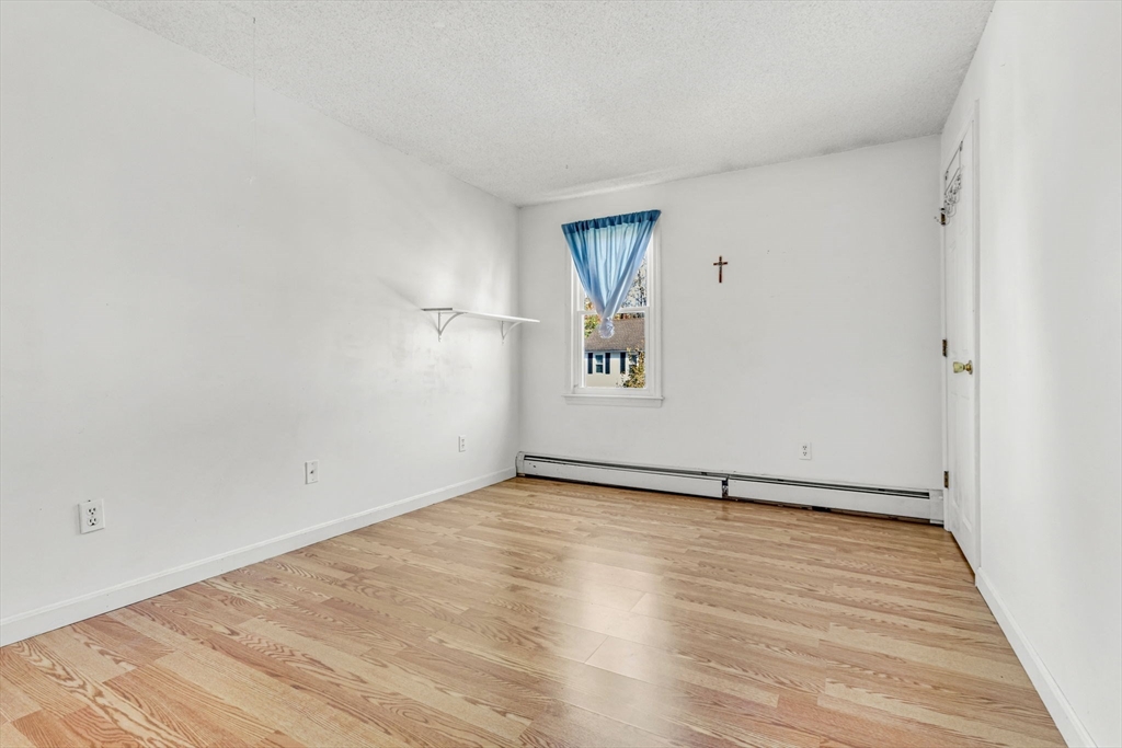 46 Vincent Circle Worcester, MA 01604 - Photo 20 of 27 a view of an empty room with wooden floor and a window