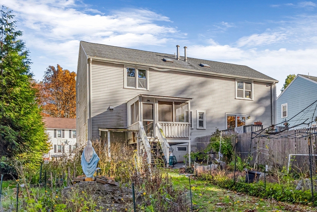46 Vincent Circle Worcester, MA 01604 - Photo 2 of 27 a view of a house with brick walls and plants next to trees