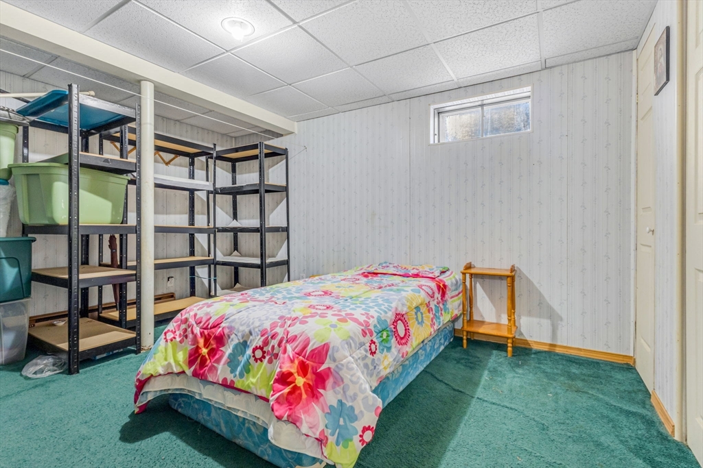 46 Vincent Circle Worcester, MA 01604 - Photo 22 of 27 a bedroom with a bed and a book shelf