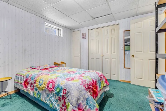 a bedroom with a bed and a baby crib