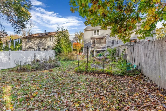 a view of a garden with wooden fence