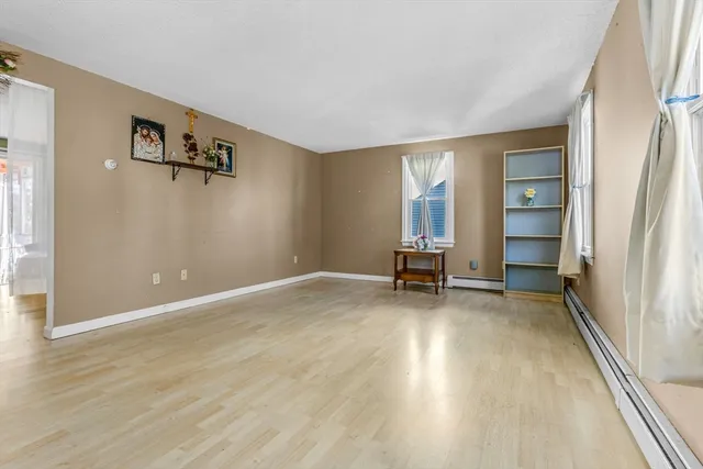 a view of a livingroom with wooden floor and a window
