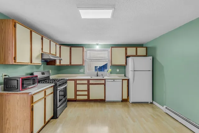 a kitchen with a sink a stove and cabinets