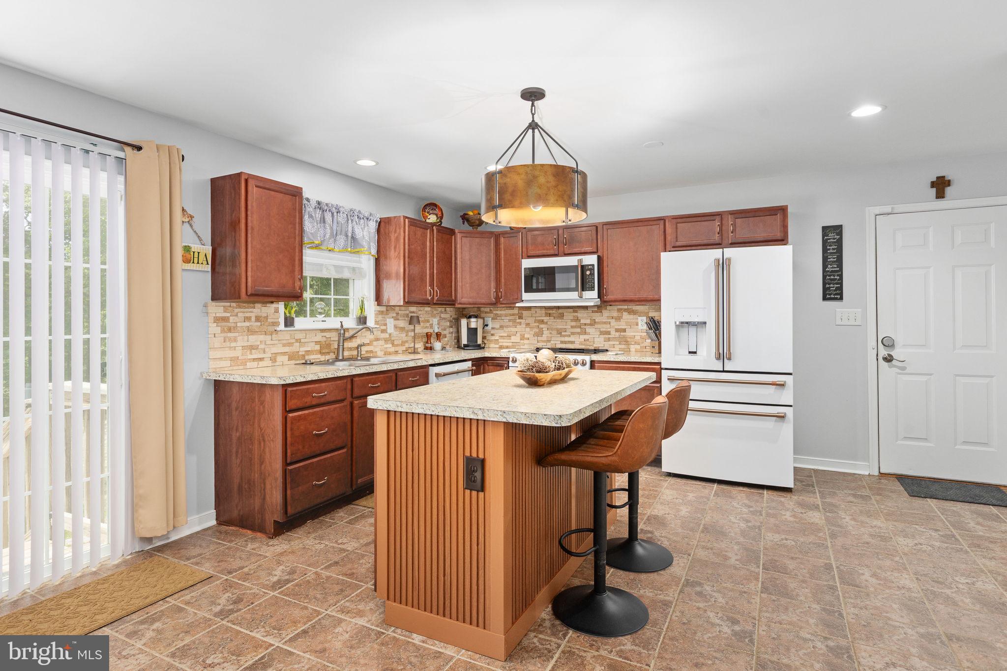 22088 Landora Bridge Road Ruther Glen, VA 22546 - Photo 38 of 122 Modern kitchen with warm wood accents.