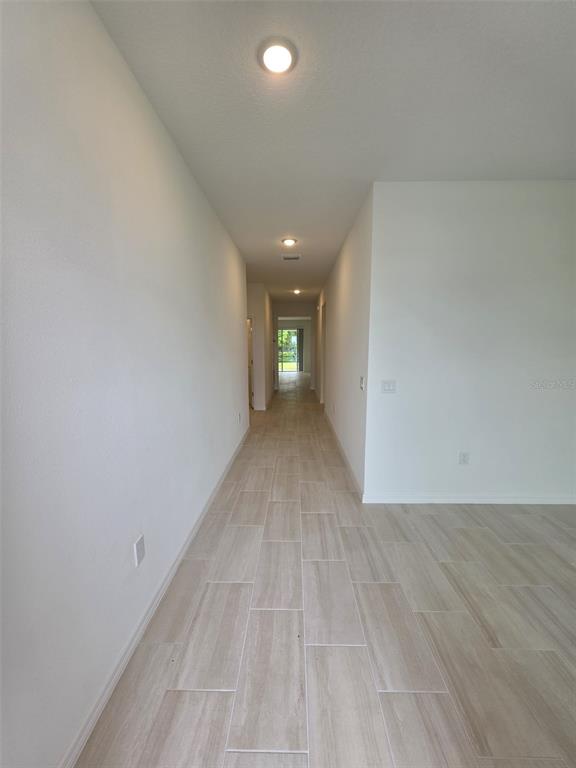 6008 Vision Road St. Cloud, FL 34771 - Photo 2 of 33 a view of a hallway with wooden floor