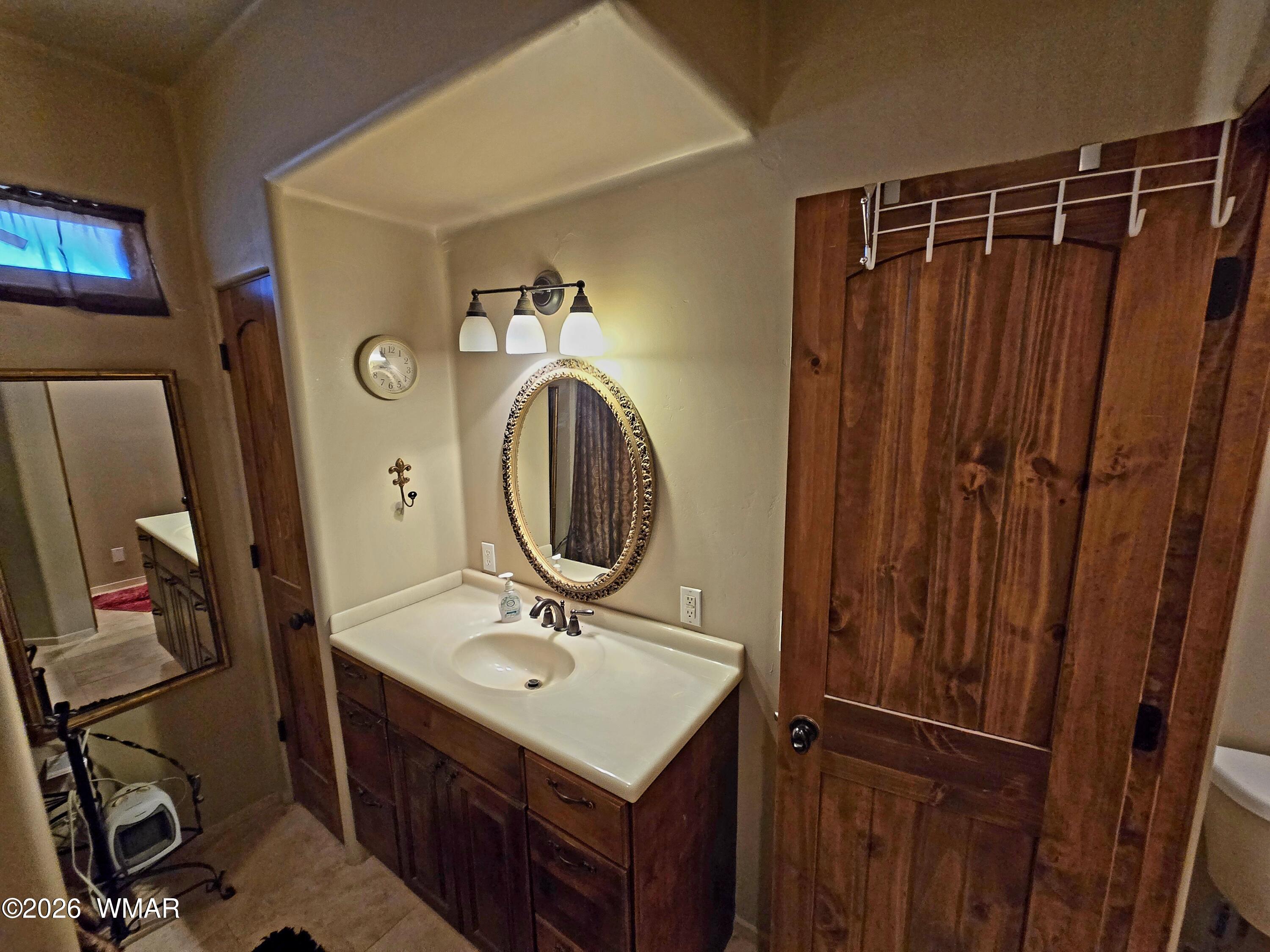 9046 Miller Trail Snowflake, AZ 85937 - Photo 22 of 34 a bathroom with a sink vanity granite and a mirror
