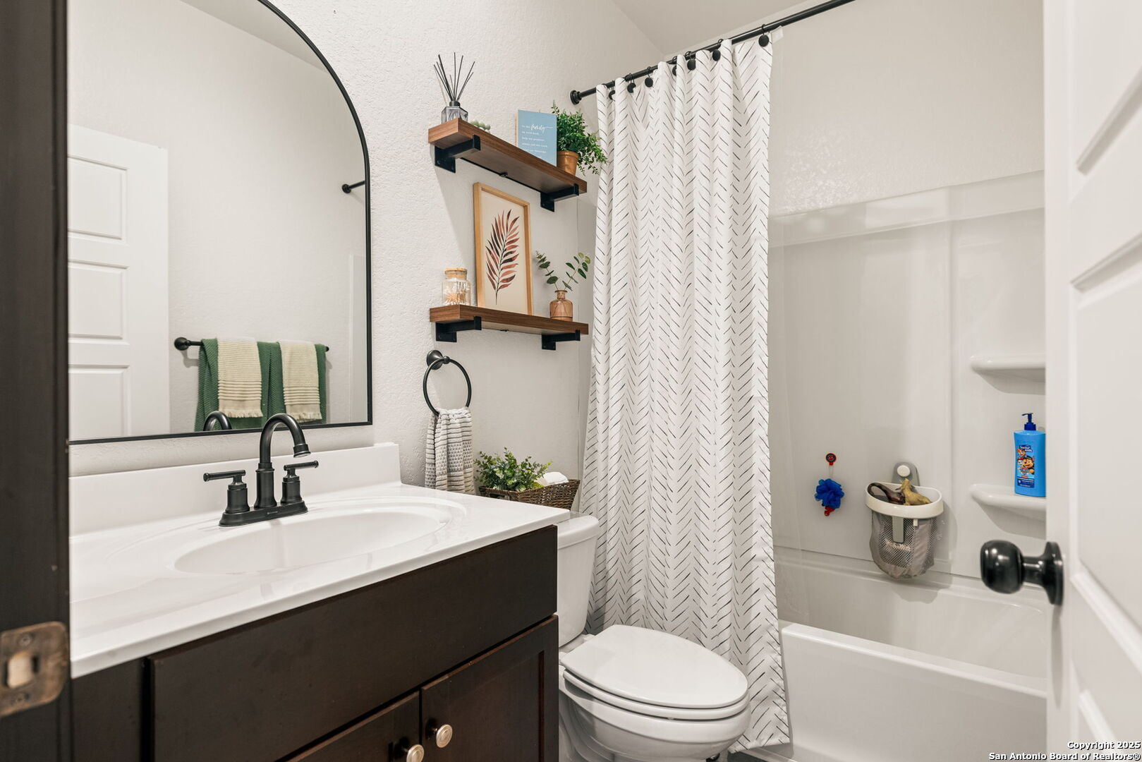 7311 Marina Del Rey Converse, TX 78109 - Photo 17 of 25 a bathroom with a sink a toilet a mirror and shower