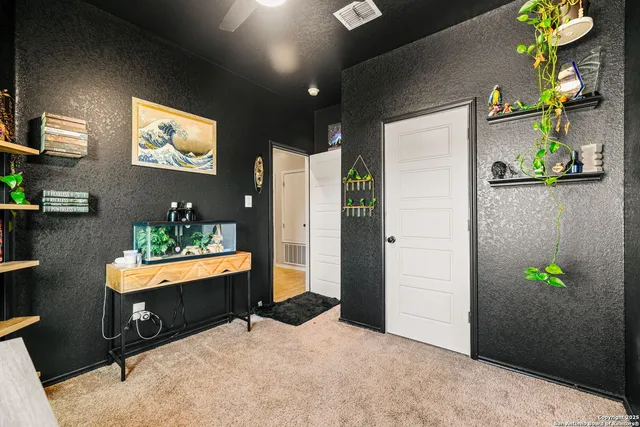 a living room with furniture and a potted plant