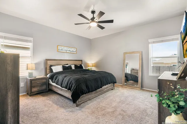 a spacious bedroom with a bed and window