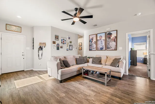 a living room with furniture and wooden floor