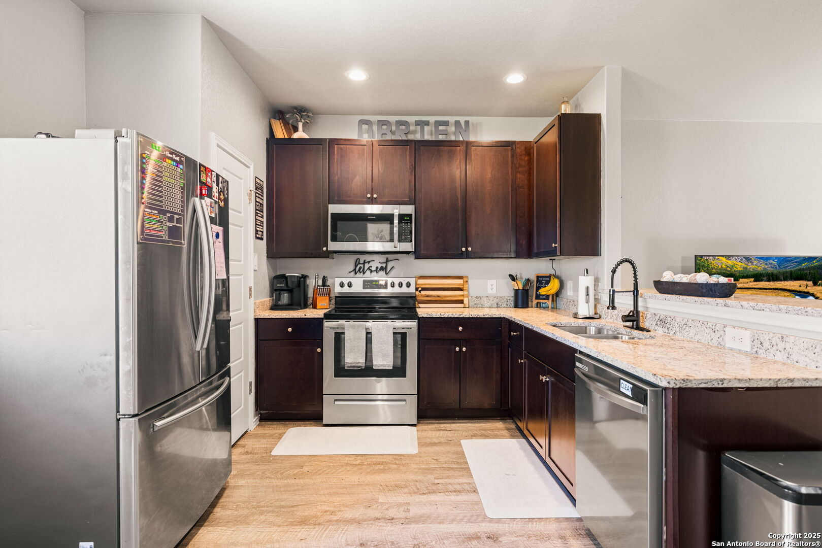 7311 Marina Del Rey Converse, TX 78109 - Photo 8 of 25 a kitchen with stainless steel appliances granite countertop a refrigerator stove and oven