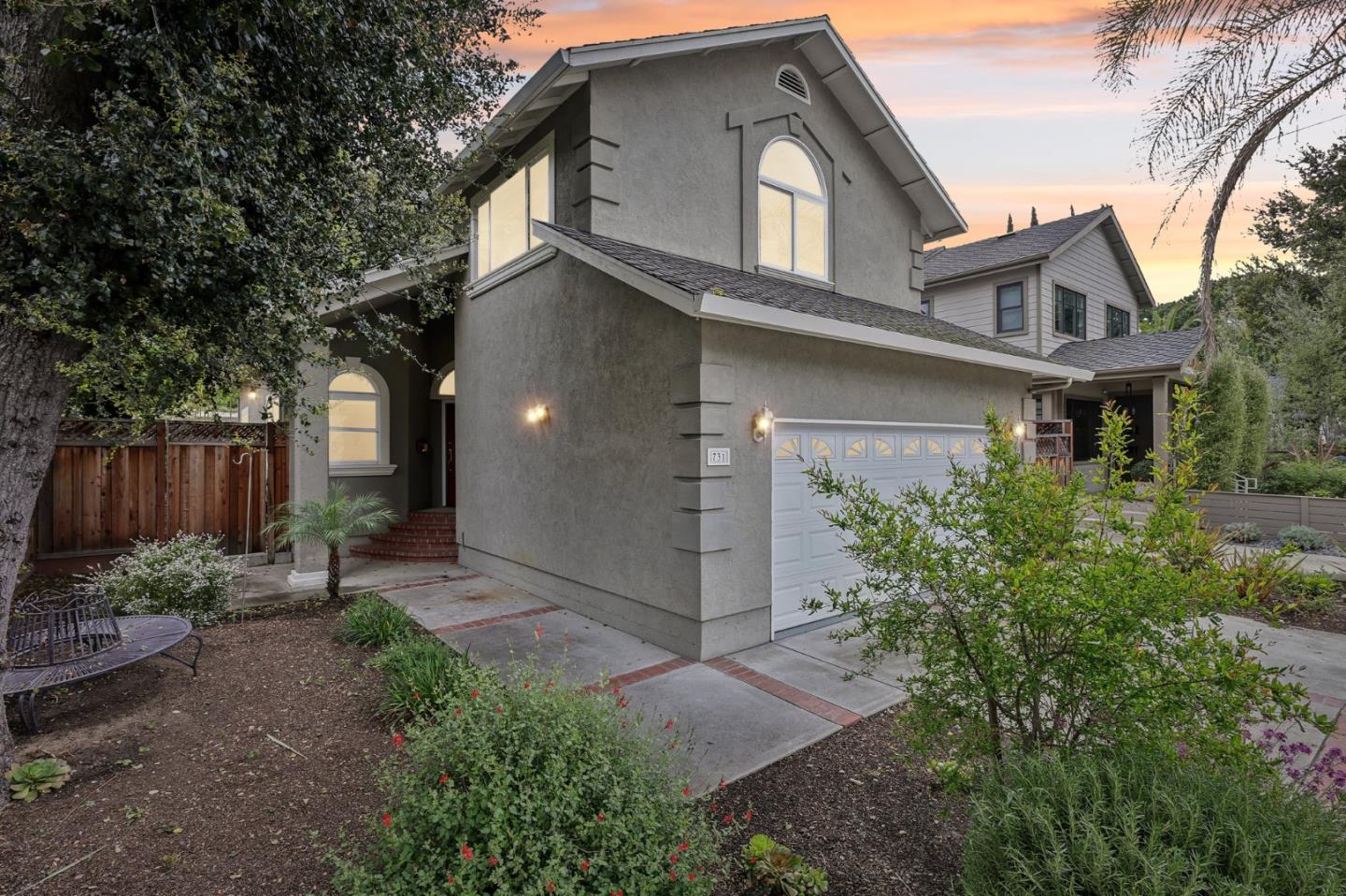731 Calderon Avenue Mountain View, CA 94041 - Photo 2 of 55 a front view of a house with a garden and trees