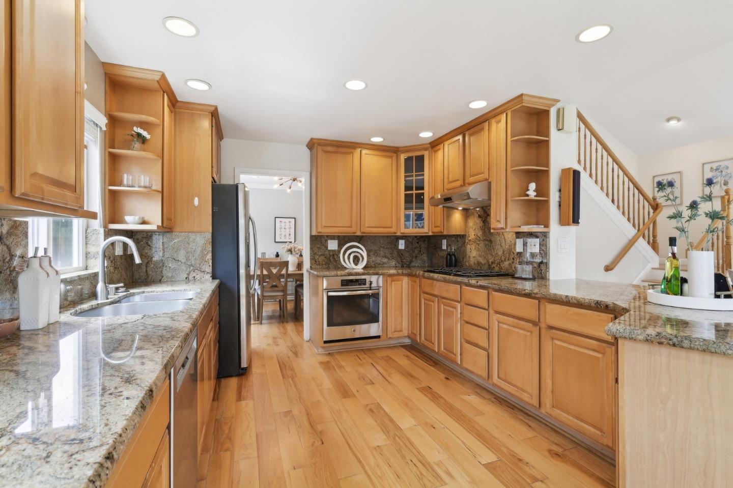 731 Calderon Avenue Mountain View, CA 94041 - Photo 21 of 55 a kitchen with stainless steel appliances granite countertop a stove and a sink