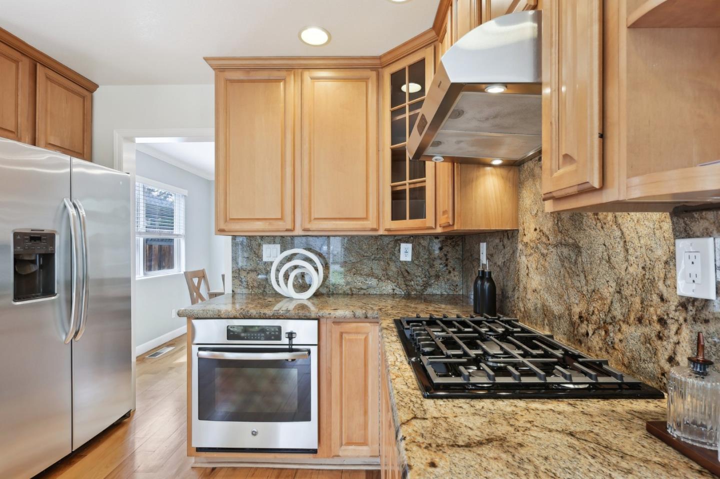 731 Calderon Avenue Mountain View, CA 94041 - Photo 22 of 55 a kitchen with stainless steel appliances granite countertop a stove and a refrigerator