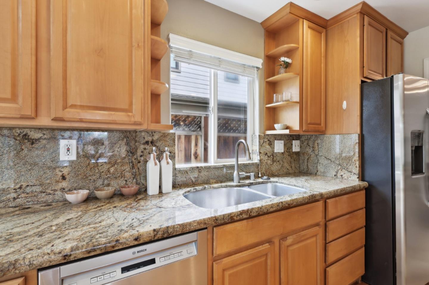 731 Calderon Avenue Mountain View, CA 94041 - Photo 23 of 55 a kitchen with granite countertop a sink and a refrigerator