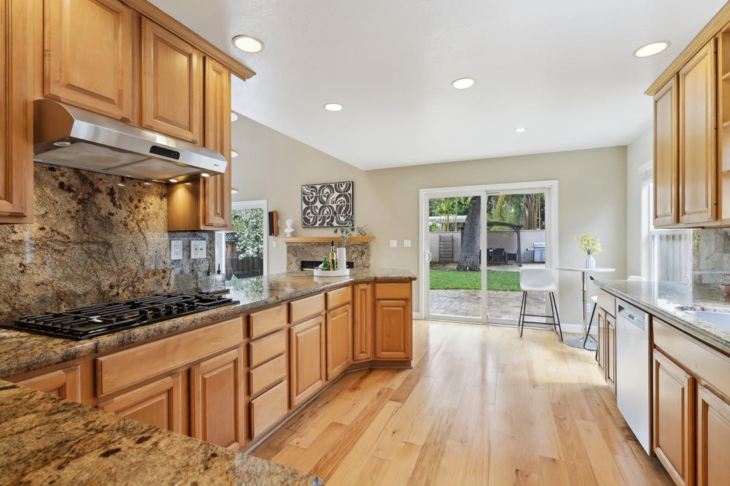 731 Calderon Avenue Mountain View, CA 94041 - Photo 24 of 55 a open kitchen with stainless steel appliances granite countertop a stove a sink and a refrigerator
