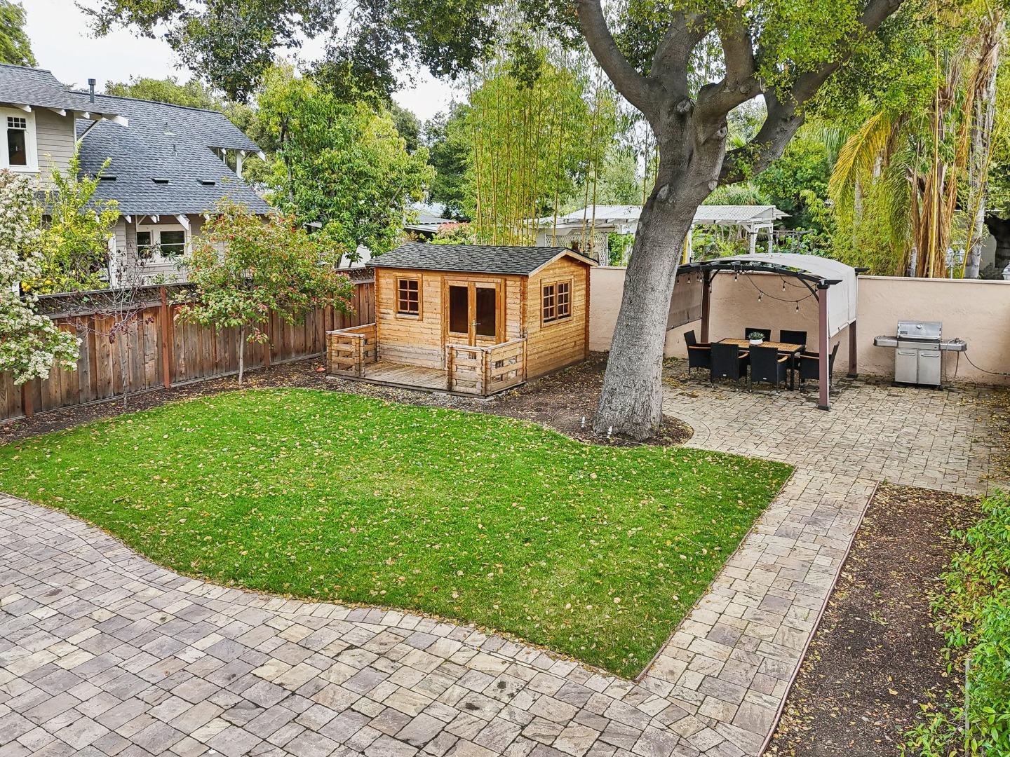 731 Calderon Avenue Mountain View, CA 94041 - Photo 46 of 55 a front view of a house with a garden and trees