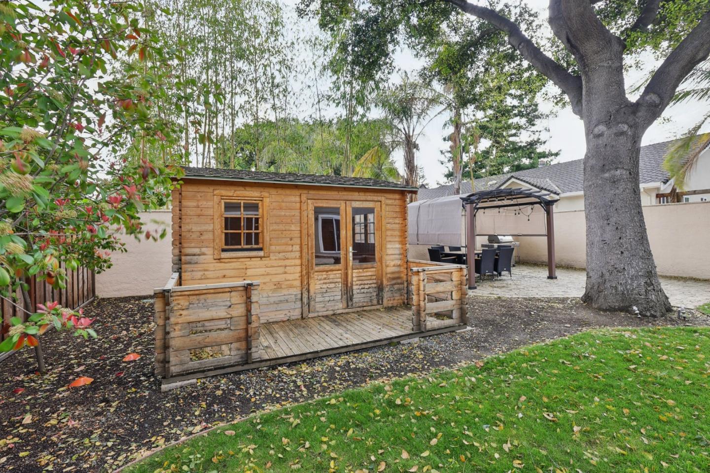 731 Calderon Avenue Mountain View, CA 94041 - Photo 5 of 55 a view of a house with backyard and a tree