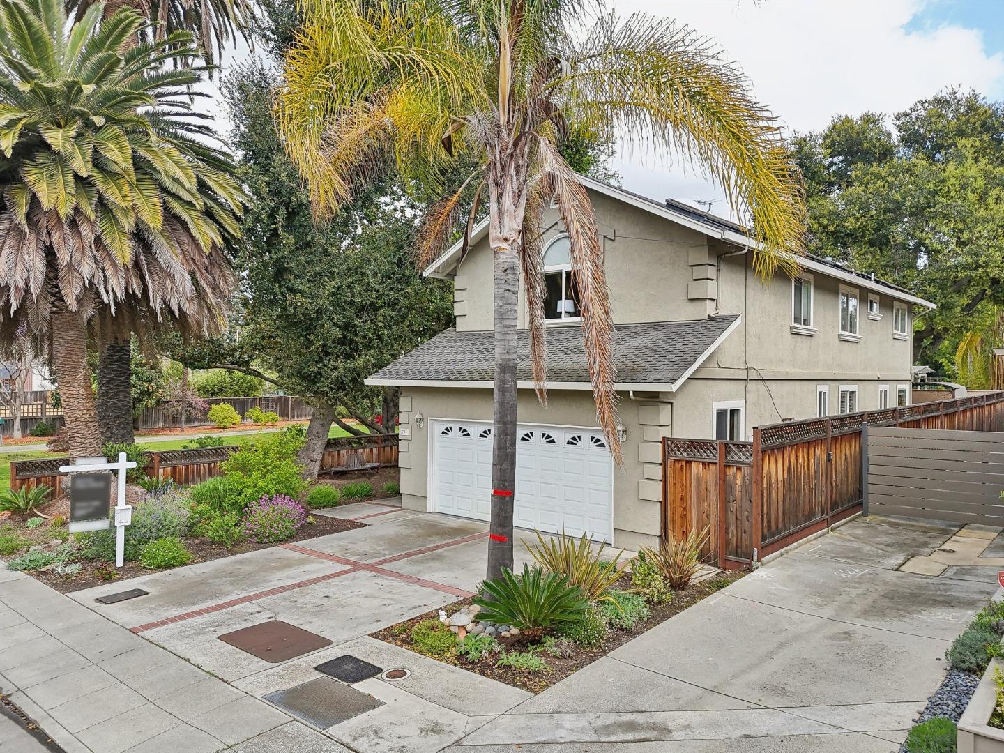 731 Calderon Avenue Mountain View, CA 94041 - Photo 7 of 55 a view of a white house with a large tree and plants