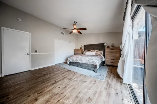 a bedroom with a bed and a ceiling fan