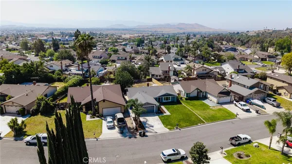 an aerial view of a houses with a swimming pool