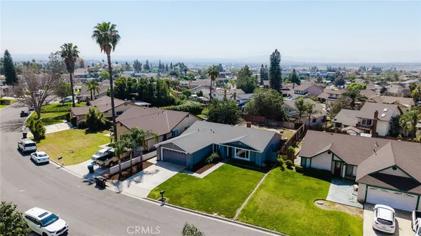 an aerial view of a house with yard swimming pool and mountain view