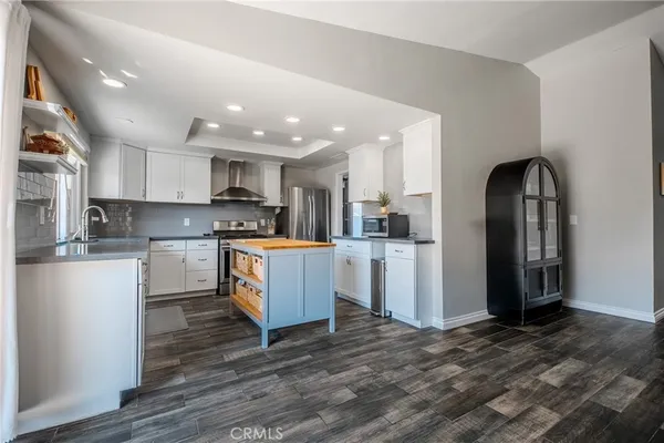 a kitchen with a refrigerator and a stove top oven