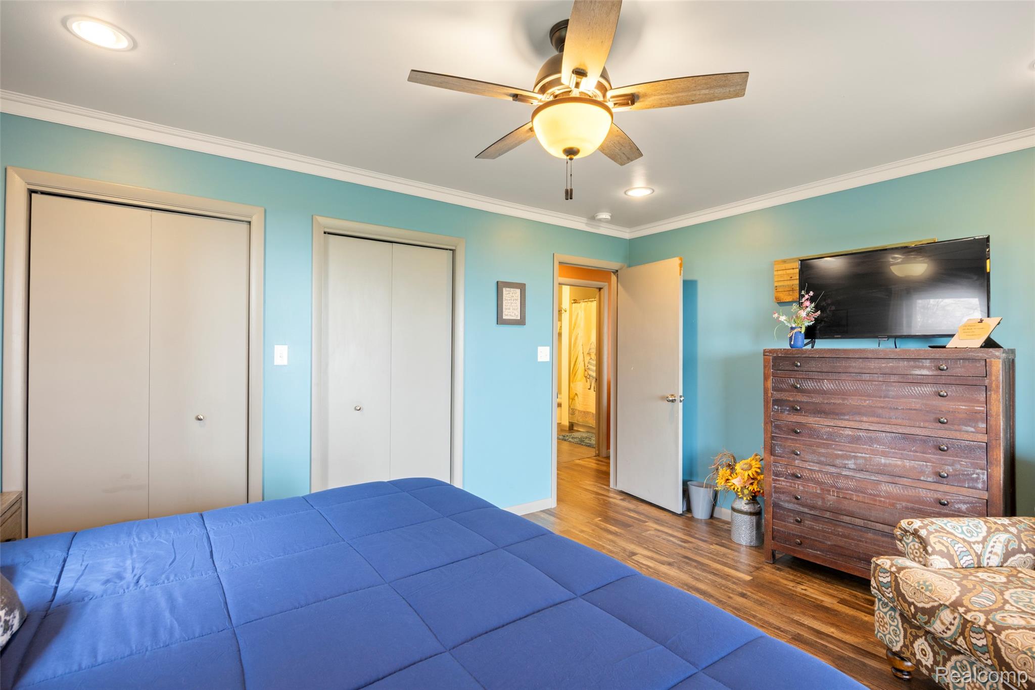 8171 Lakeshore Road Lexington, MI 48450 - Photo 23 of 45 Bedroom featuring multiple closets, wood finished floors, ornamental molding, ceiling fan, and recessed lighting
