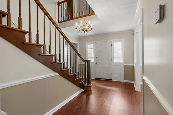 a view of entryway with stairs and wooden floor