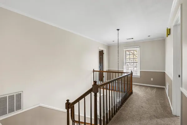 a view of entryway and hall with chandelier