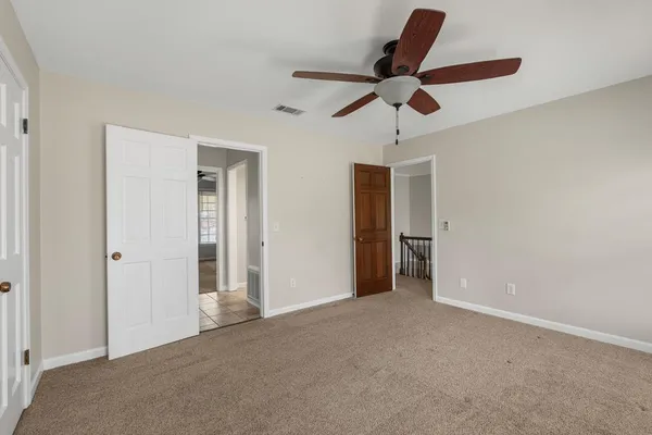 a view of empty room with ceiling fan