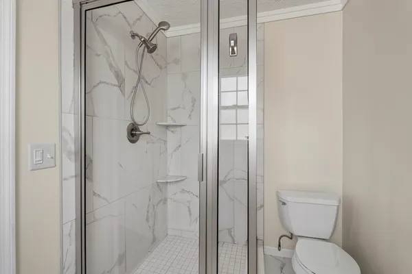 a bathroom with a toilet and shower