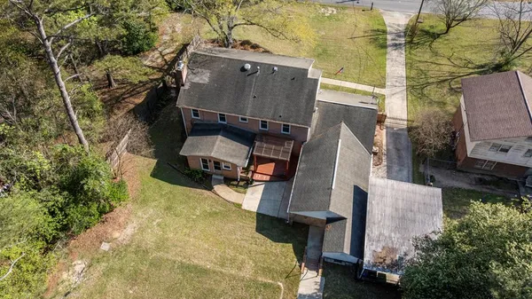 an aerial view of a house with swimming pool and wooden fence