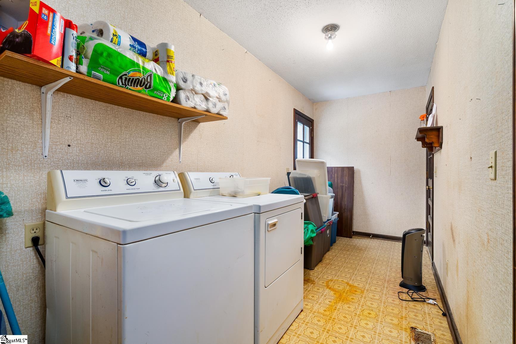 640 Shirley Store Road Anderson, SC 29621 - Photo 13 of 30 Laundry Room is off of the Living room and has a door that leads out to the back deck and a door that leads out to the single car garage. Size:14.3 X 6.2