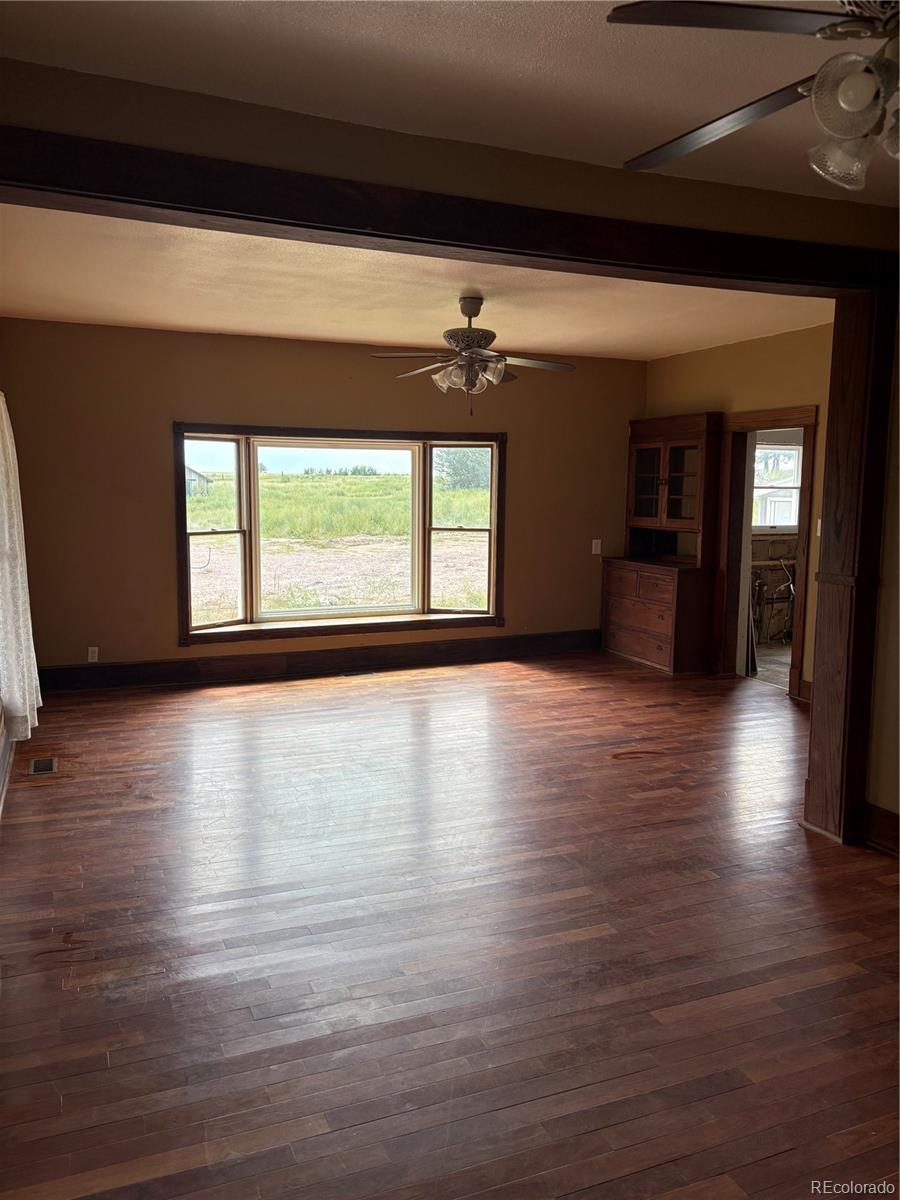 16154 County Road 24 Sterling, CO 80751 - Photo 14 of 28 an empty room with wooden floor and windows